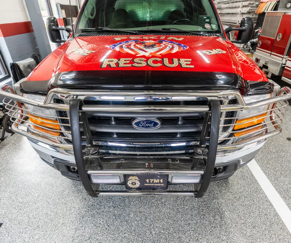 A firetruck parked on a stunning Elite Coatings Penntek floor, showcasing the floor's smooth, durable, and polished surface, enhancing the overall aesthetic of the space.