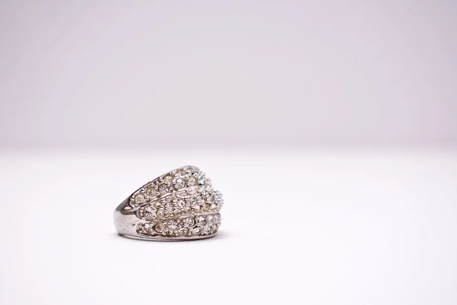 Close-up of a stylish diamond ring with minimalist white background.