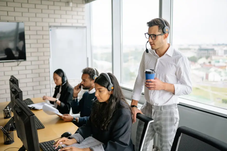 A diverse group of employees working together in a bright, modern call center with headsets.