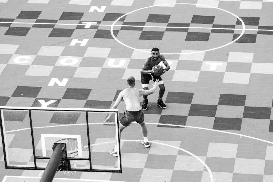 Grayscale Photo of Men Playing Basketball