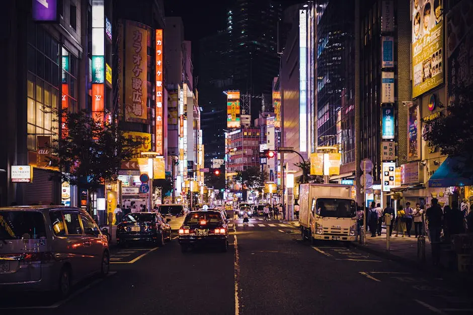 Dynamic nighttime scene in Tokyo with bustling traffic and vivid neon lights illuminating the city.