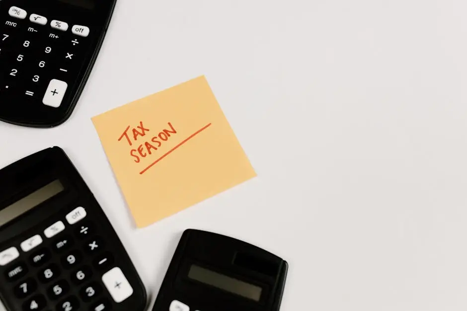 Calculators and sticky note labeled ‘Tax Season’ on white background, ideal for financial themes.