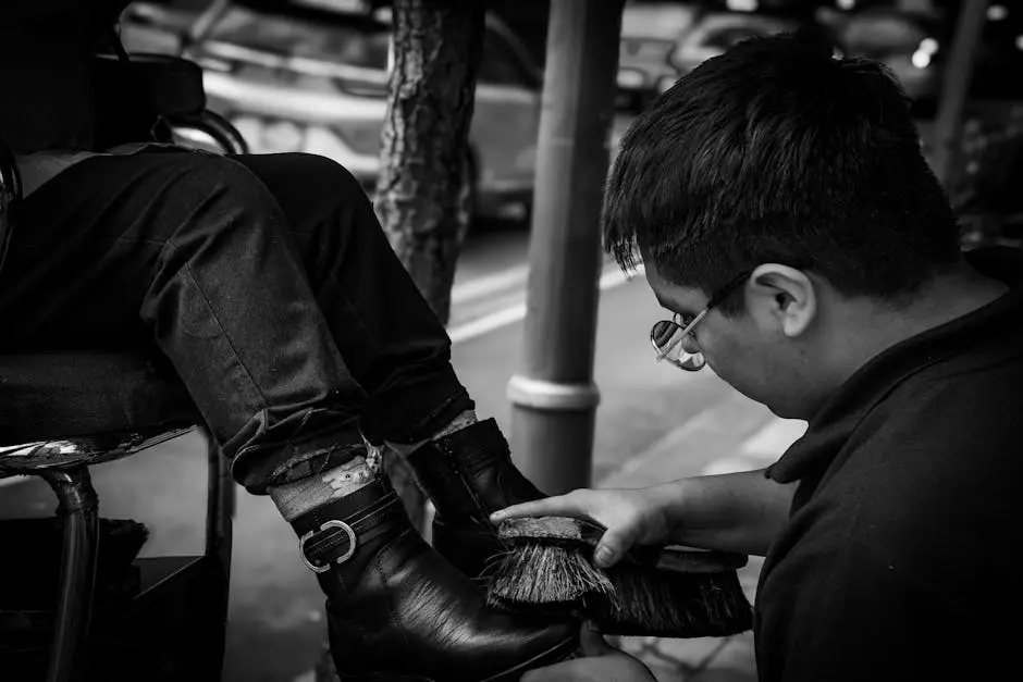 A man is putting on a pair of boots