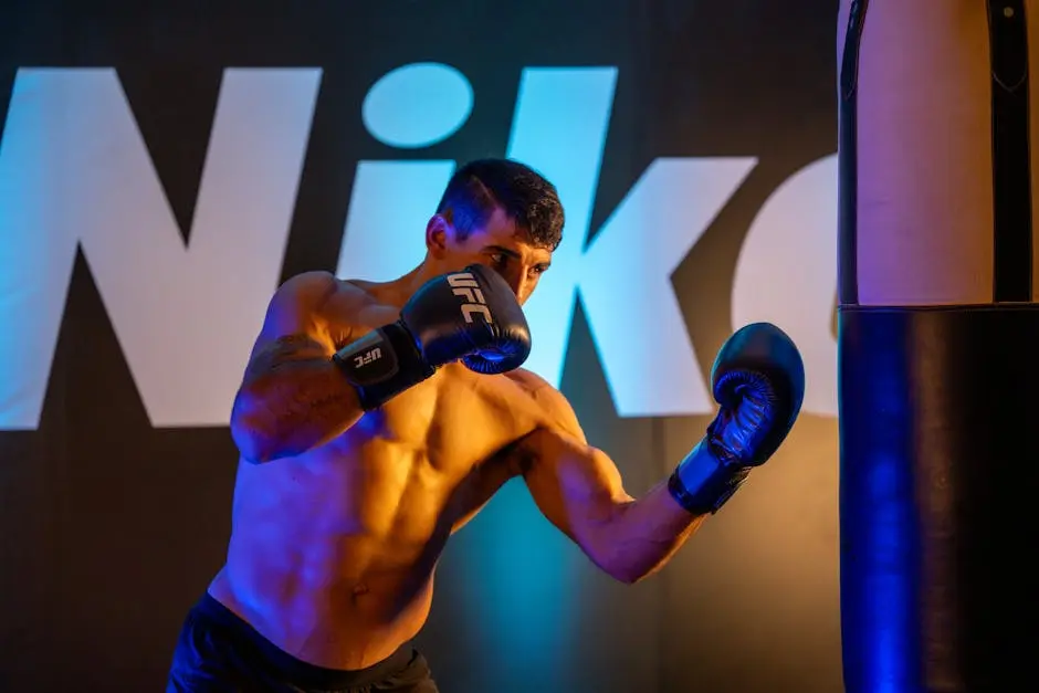 A man in boxing gear with a black background