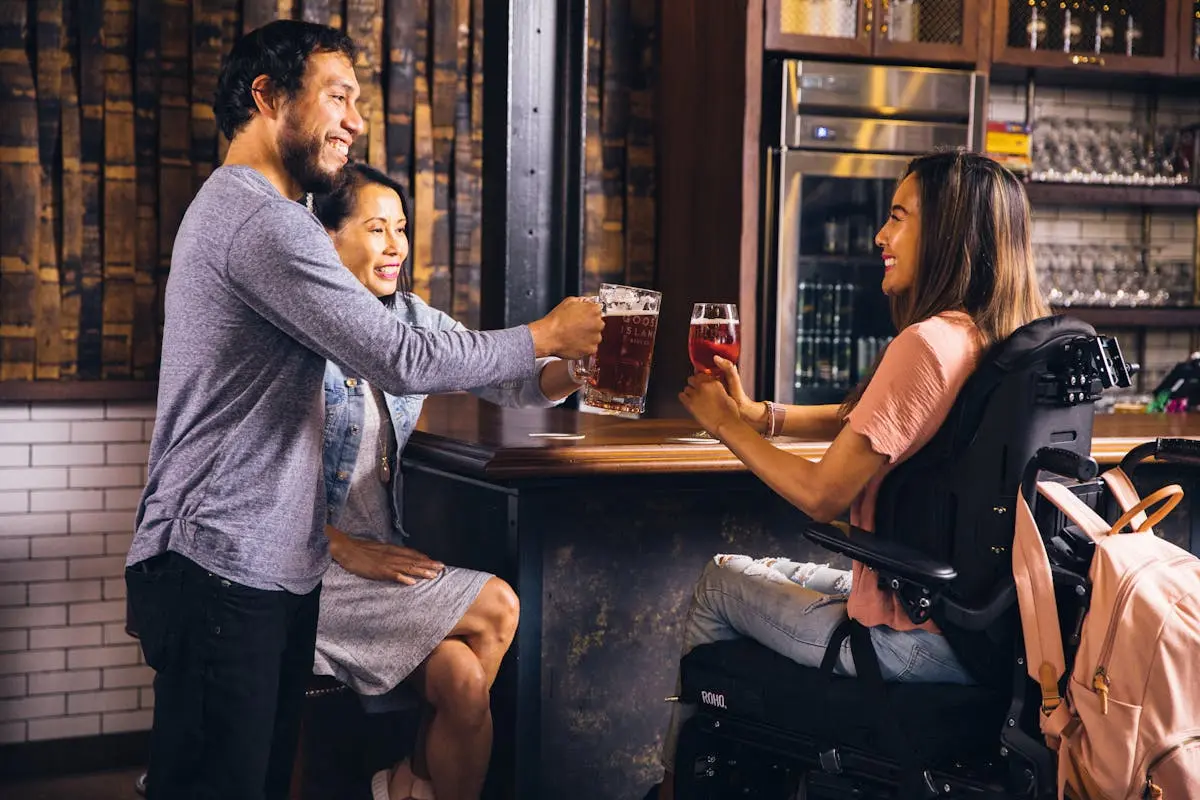 Three Smiling People Toasting Their Drinks