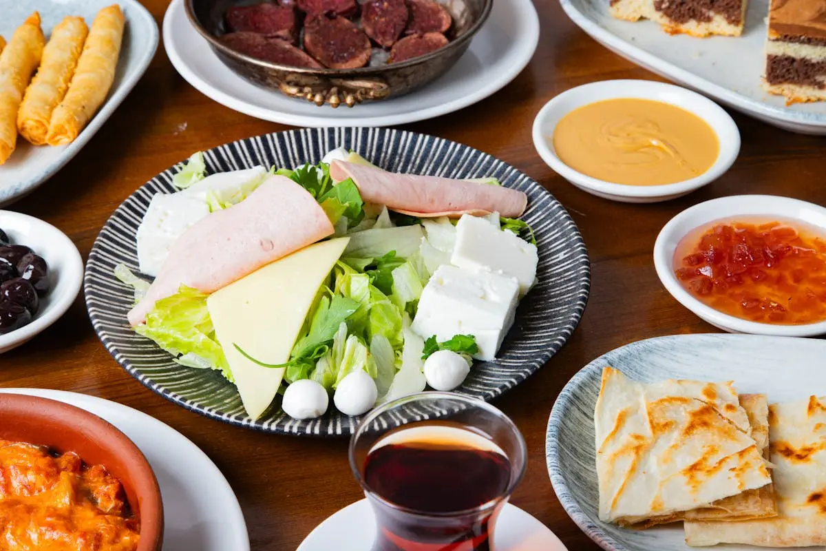 A table with plates of food and drinks