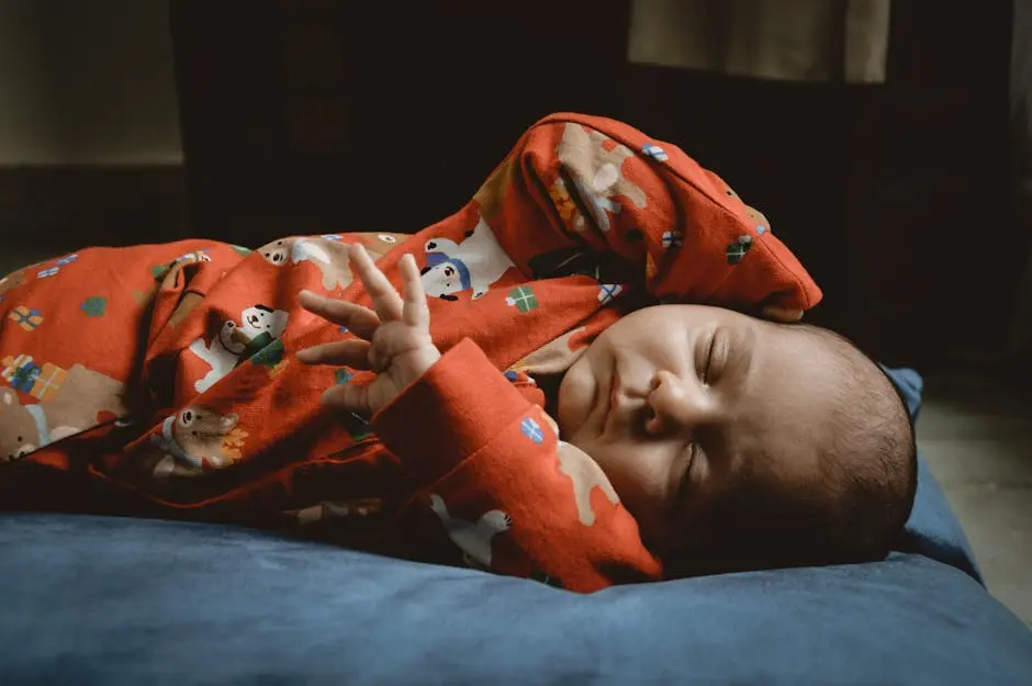 A baby sleeping on a blue blanket