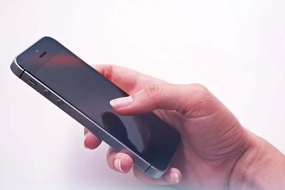 A person’s hand holding a smartphone, showcasing modern technology and connectivity.