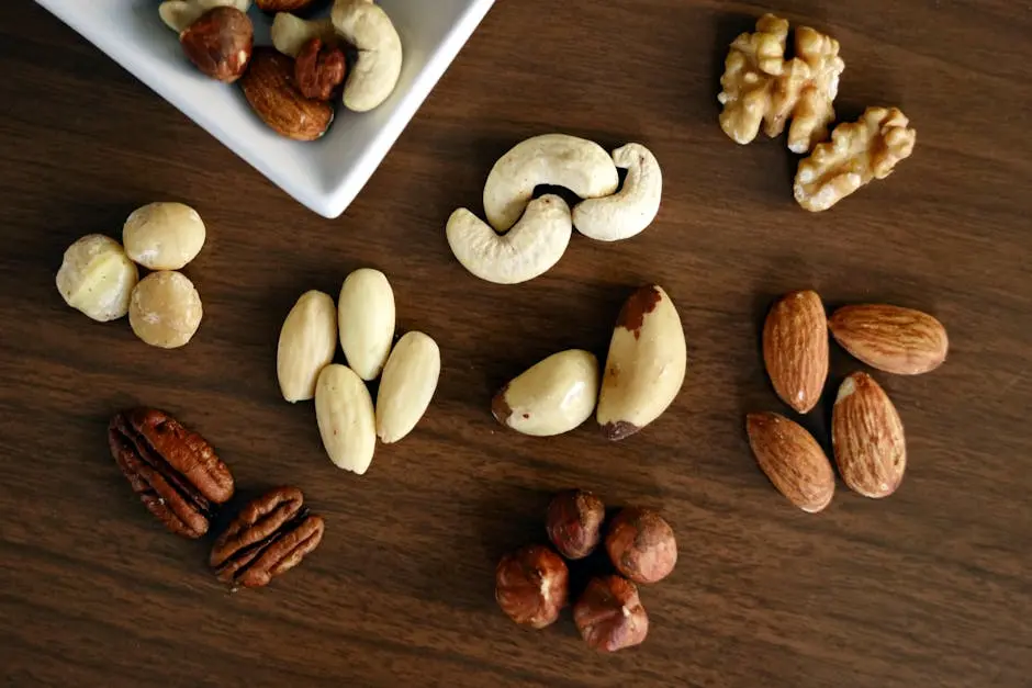 Close-up of various nuts on a wooden table, showcasing healthy snacking options.