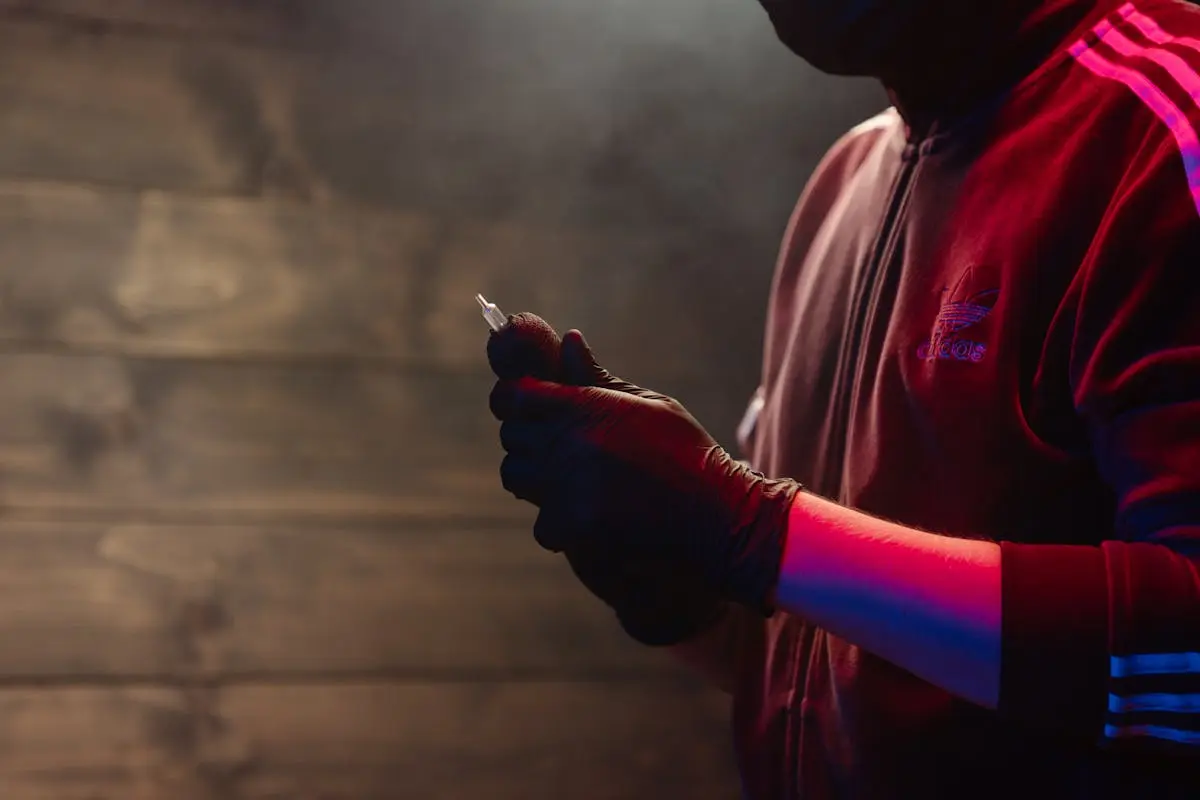 Man in Red Hoodie Holding Cigarette Stick