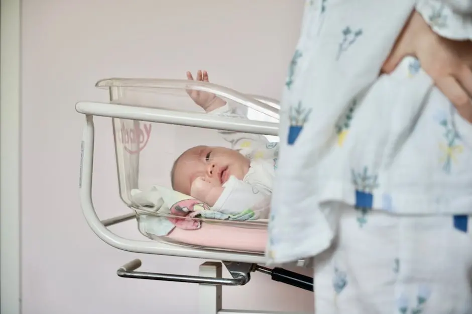 A Newborn Baby Lying in a Hospital Infant Bassinet