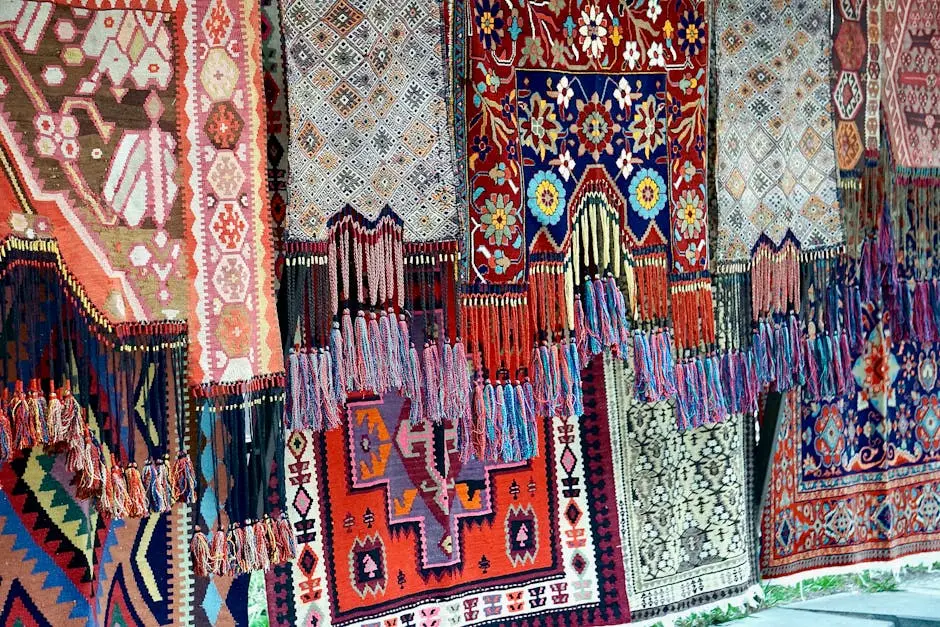 Vibrant display of traditional handmade rugs at a market showcasing intricate patterns and craftsmanship.