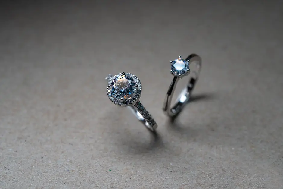 Close-up image of luxury diamond engagement rings on a neutral background.