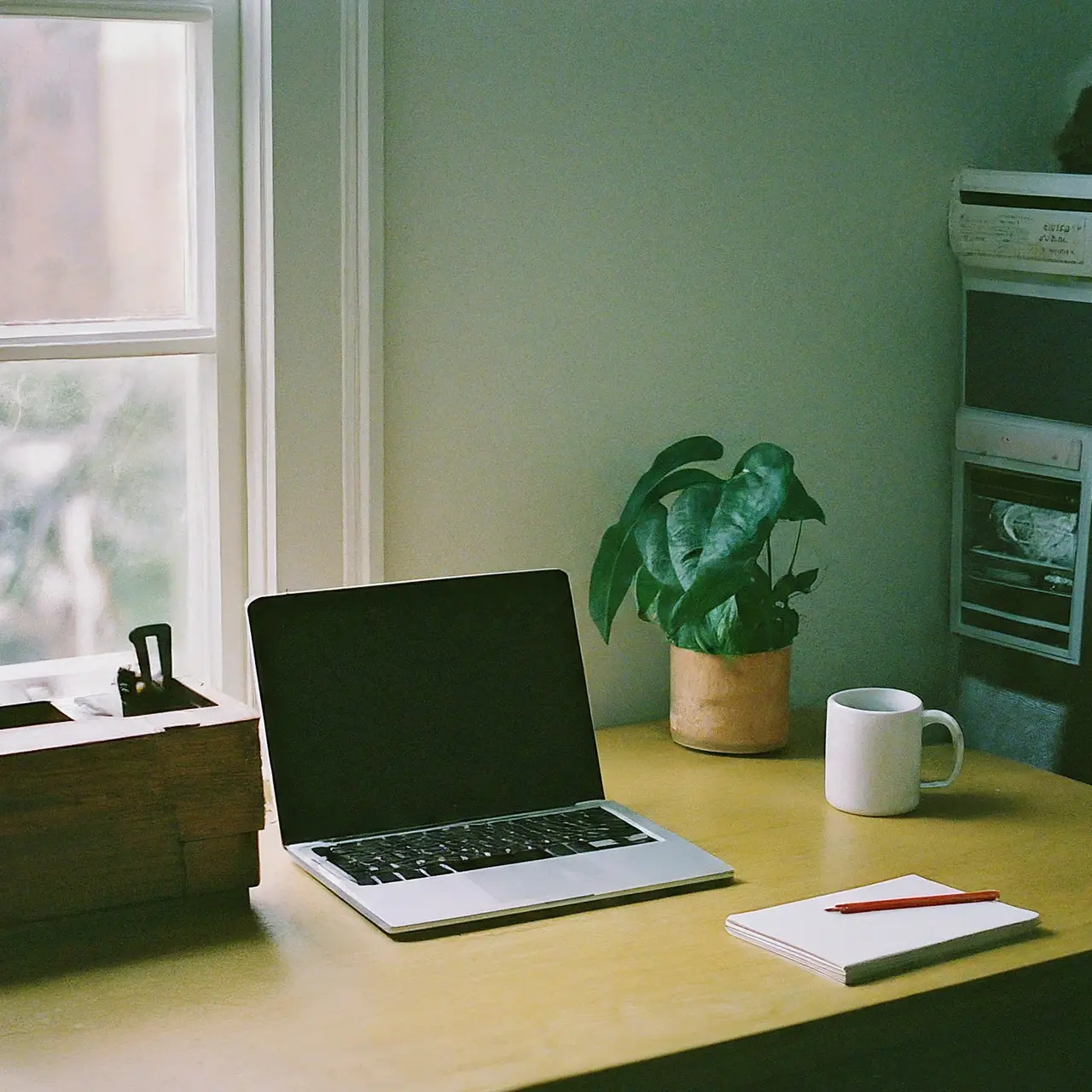 A home office desk with a laptop and a coffee mug. 35mm stock photo