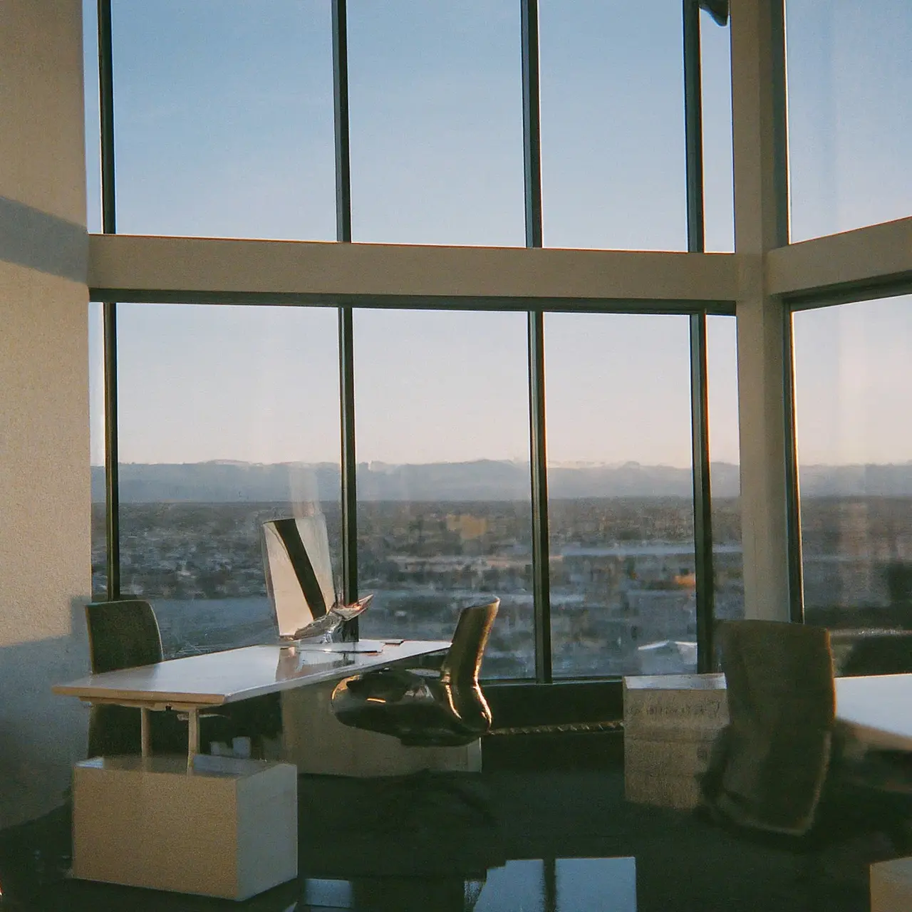 An office with modern standing desks and panoramic Denver views. 35mm stock photo