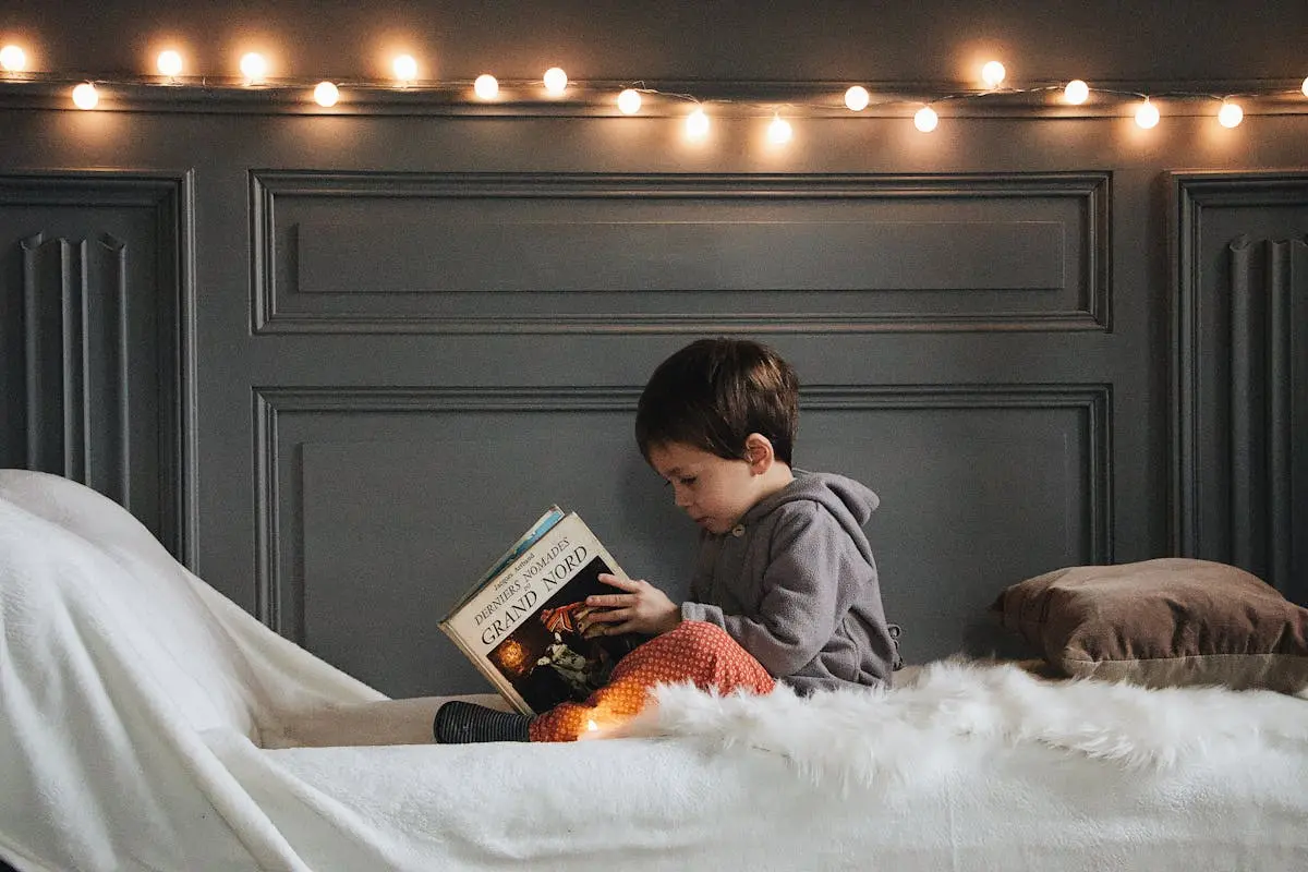 Boy in Gray Jacket Reading Book about sharks