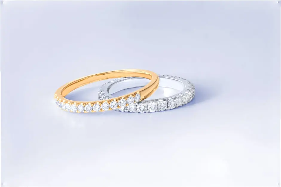 Close-up of two exquisite diamond rings in gold and silver settings, showcasing luxury and craftsmanship.